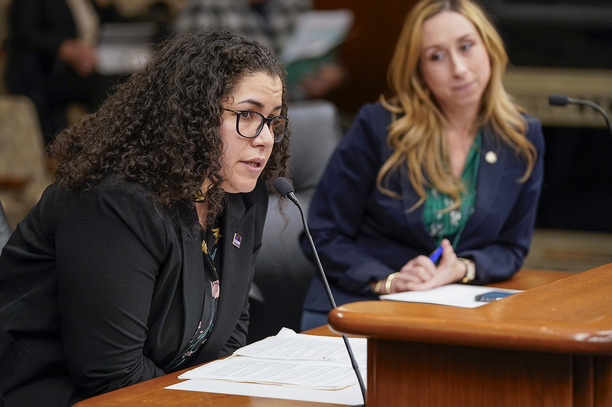 Samantha Diaz, political director at SEIU Local 26, tells the House Labor and Industry Finance and Policy Committee Tuesday of her support for HF4818, to provide health and welfare benefits to private employees at the Minneapolis-St. Paul International Airport. Rep. Kaela Berg sponsors the bill. (Photo by Michele Jokinen)